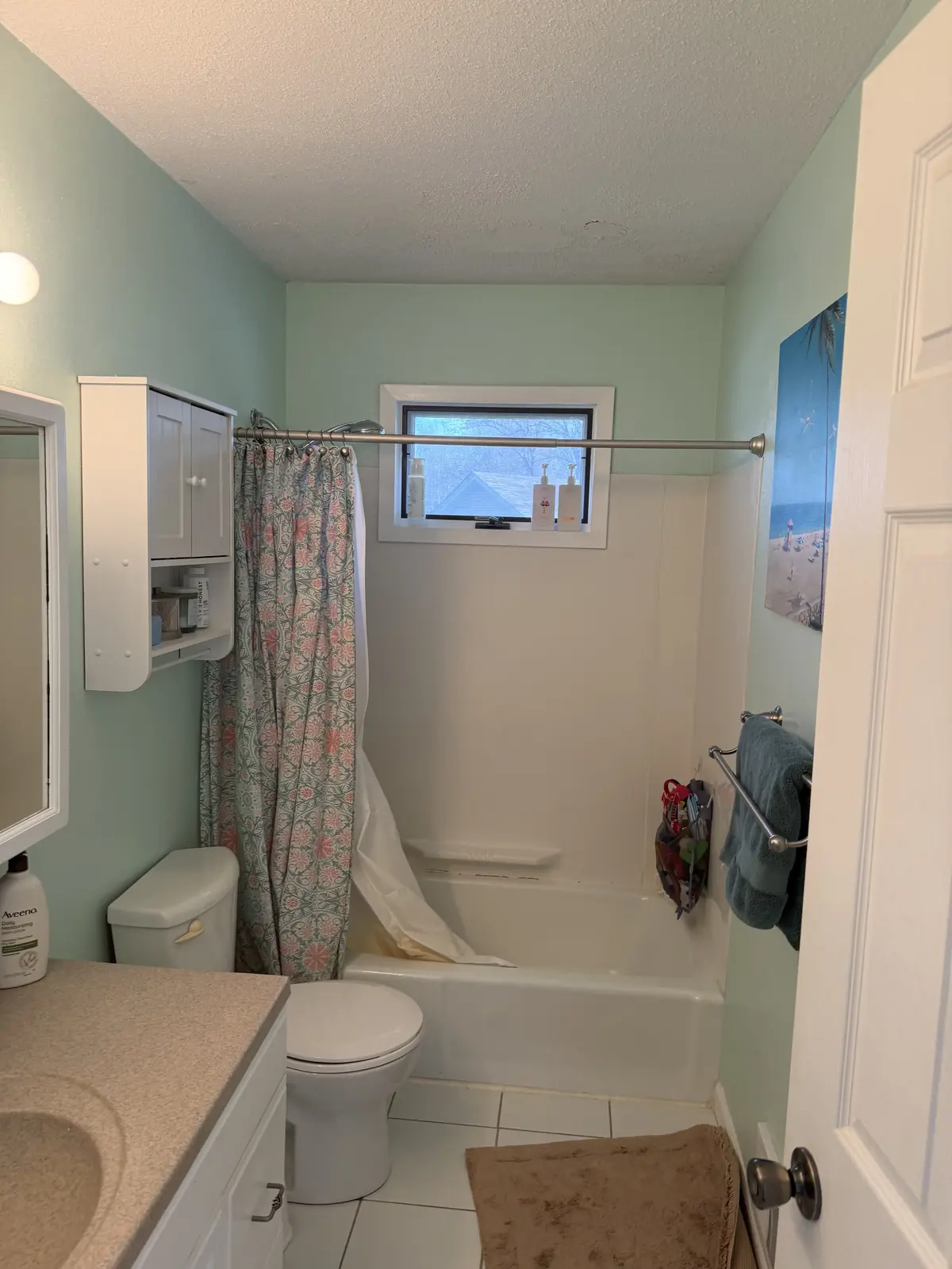 The original upstairs bathroom, with the tub and window retained in the remodel.